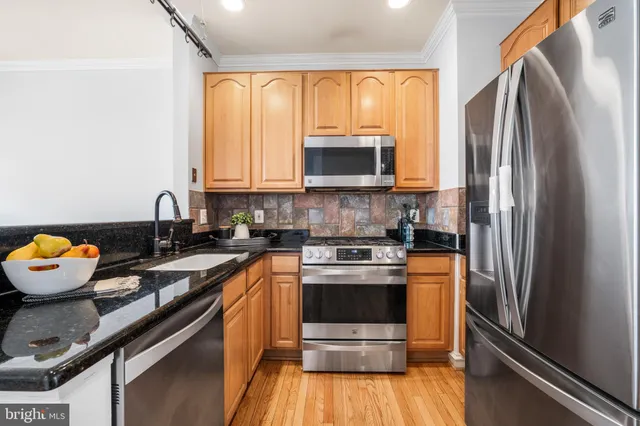 a kitchen with a sink stove and refrigerator