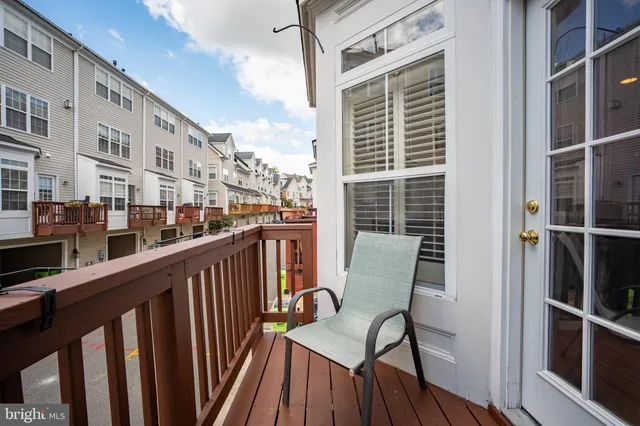 a view of balcony with a large window and wooden floor