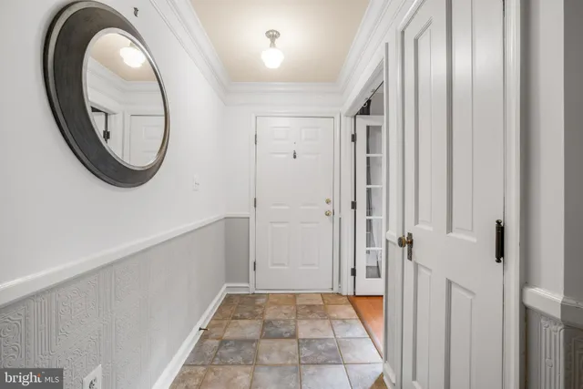 a view of a hallway with wooden floor