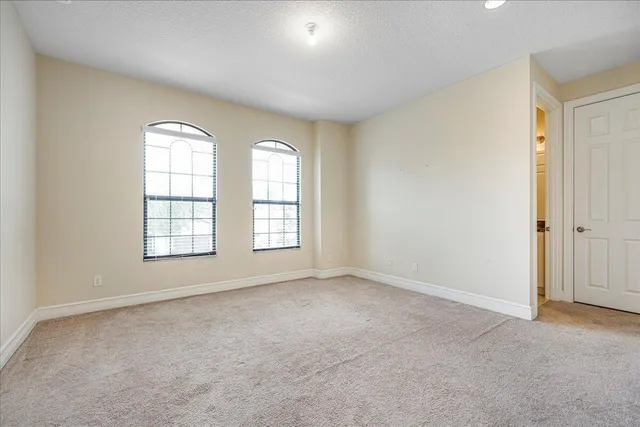 a bathroom with a granite countertop sink a toilet and shower
