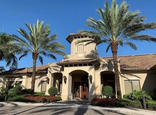 a row of palm trees and swimming pool in the backyard of a house