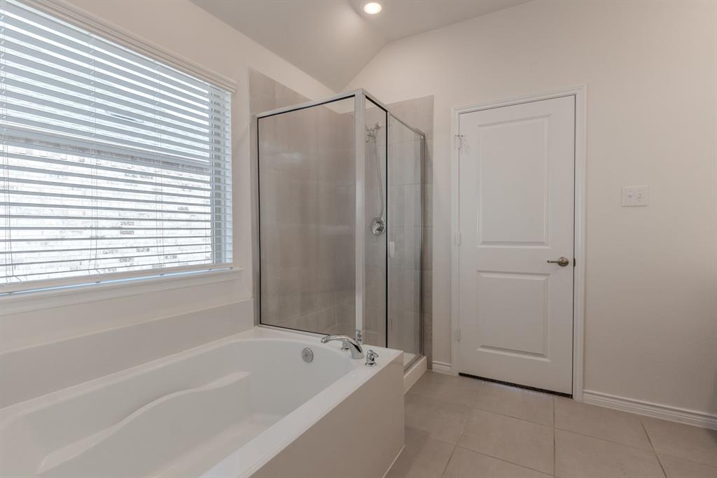 2902 Trusting Way Aubrey, TX 76227 - Photo 29 of 38 Bathroom featuring a white built-in bathtub with polished chrome fixtures, a clear glass shower enclosure with coordinating chrome hardware, tile flooring, and a window with horizontal blinds
