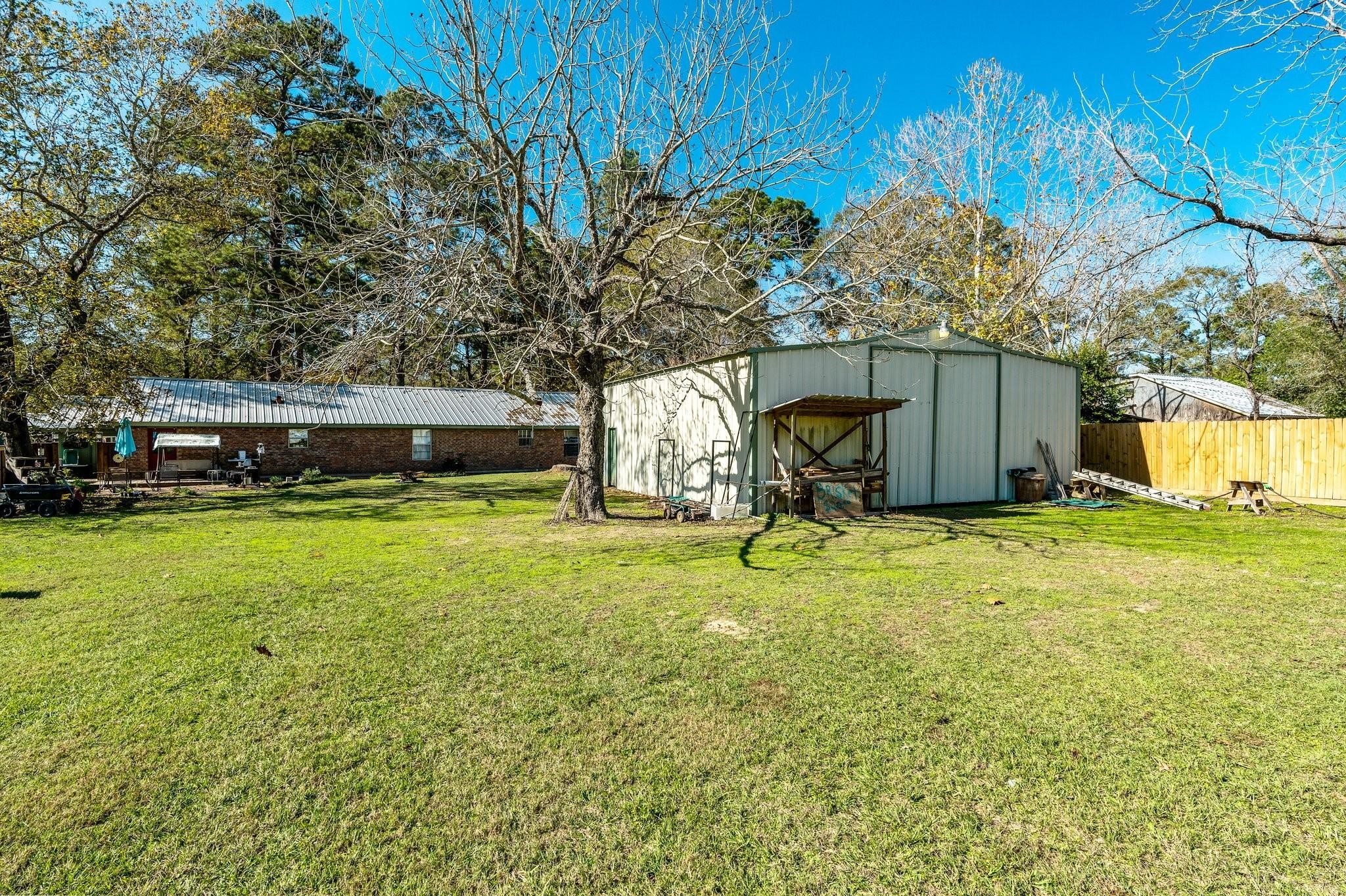 15091 Farm To Market 1485 Conroe, TX 77306 - Photo 23 of 28 a view of a house with backyard