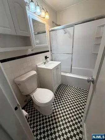 a bathroom with a toilet a sink and a mirror