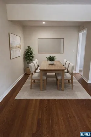 a living room with furniture rug and wooden floor