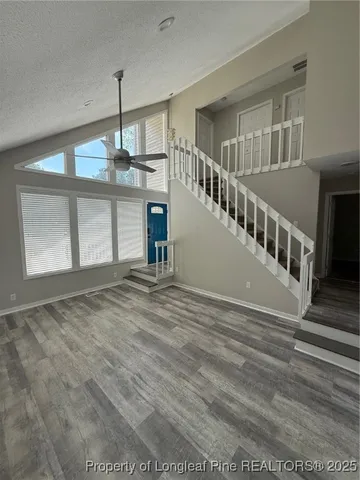 a view of an empty room with a window and fireplace