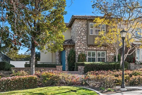 front view of a house with a tree