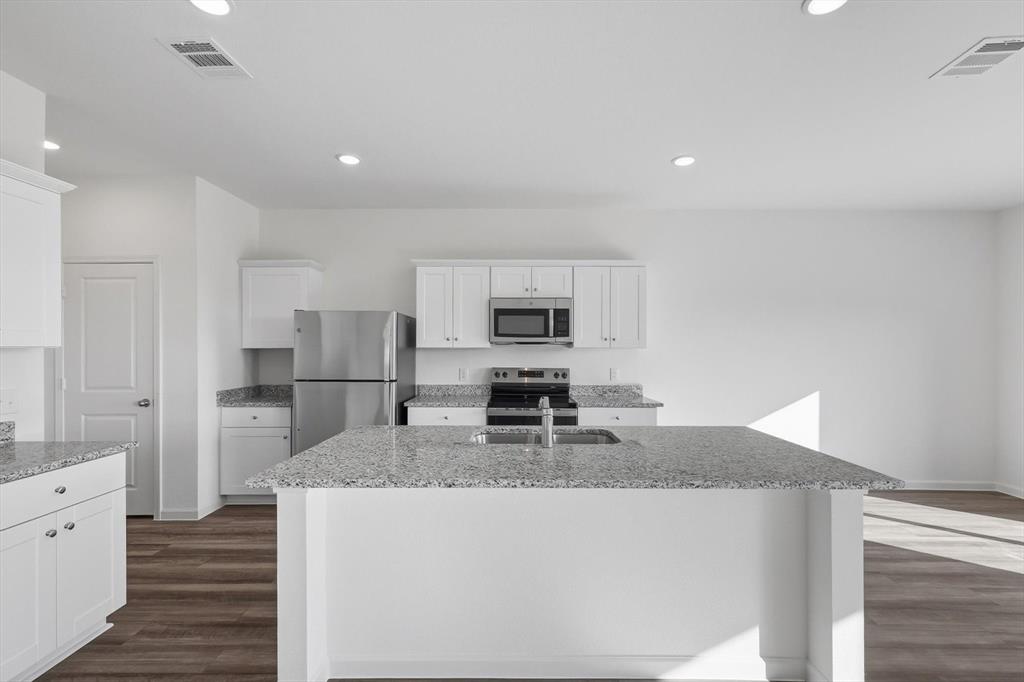 2018 Prairie Lane Melissa, TX 75454 - Photo 12 of 40 a kitchen with stainless steel appliances granite countertop a sink stove and refrigerator