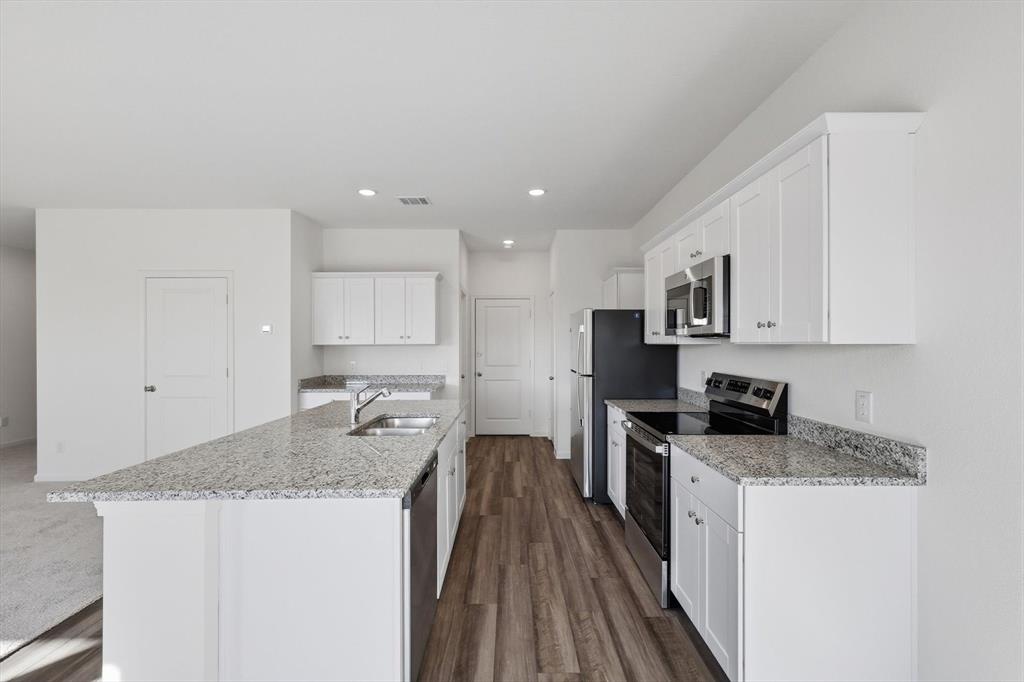 2018 Prairie Lane Melissa, TX 75454 - Photo 13 of 40 a kitchen with granite countertop stainless steel appliances refrigerator sink and cabinets