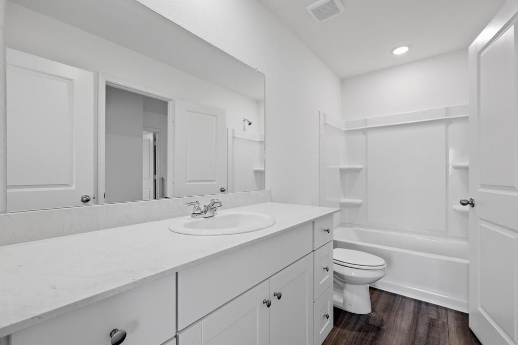 2018 Prairie Lane Melissa, TX 75454 - Photo 22 of 40 a bathroom with a sink toilet and shower