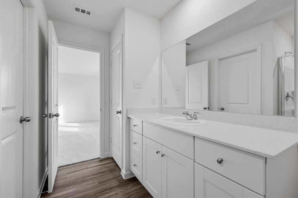 2018 Prairie Lane Melissa, TX 75454 - Photo 30 of 40 a bathroom with a granite countertop sink and a mirror