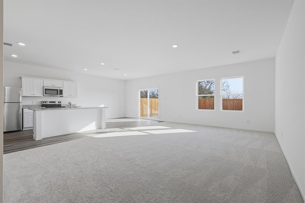 2018 Prairie Lane Melissa, TX 75454 - Photo 5 of 40 a view of kitchen with white cabinets and wooden floor