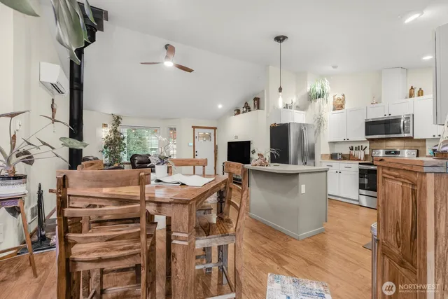 a kitchen with kitchen island a large counter top space appliances and cabinets