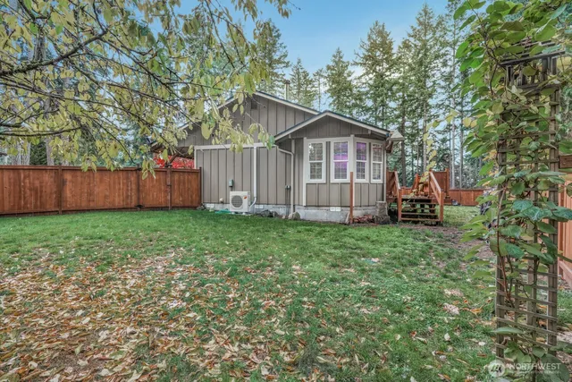 a view of a small house with a yard