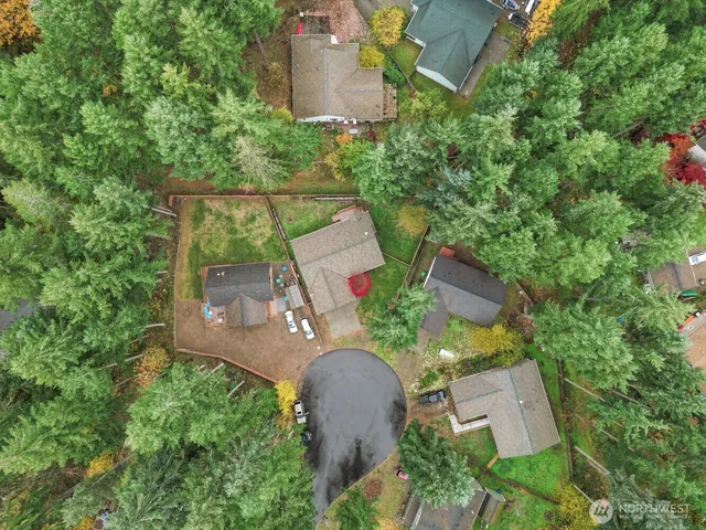 an aerial view of a house with outdoor space and sitting area