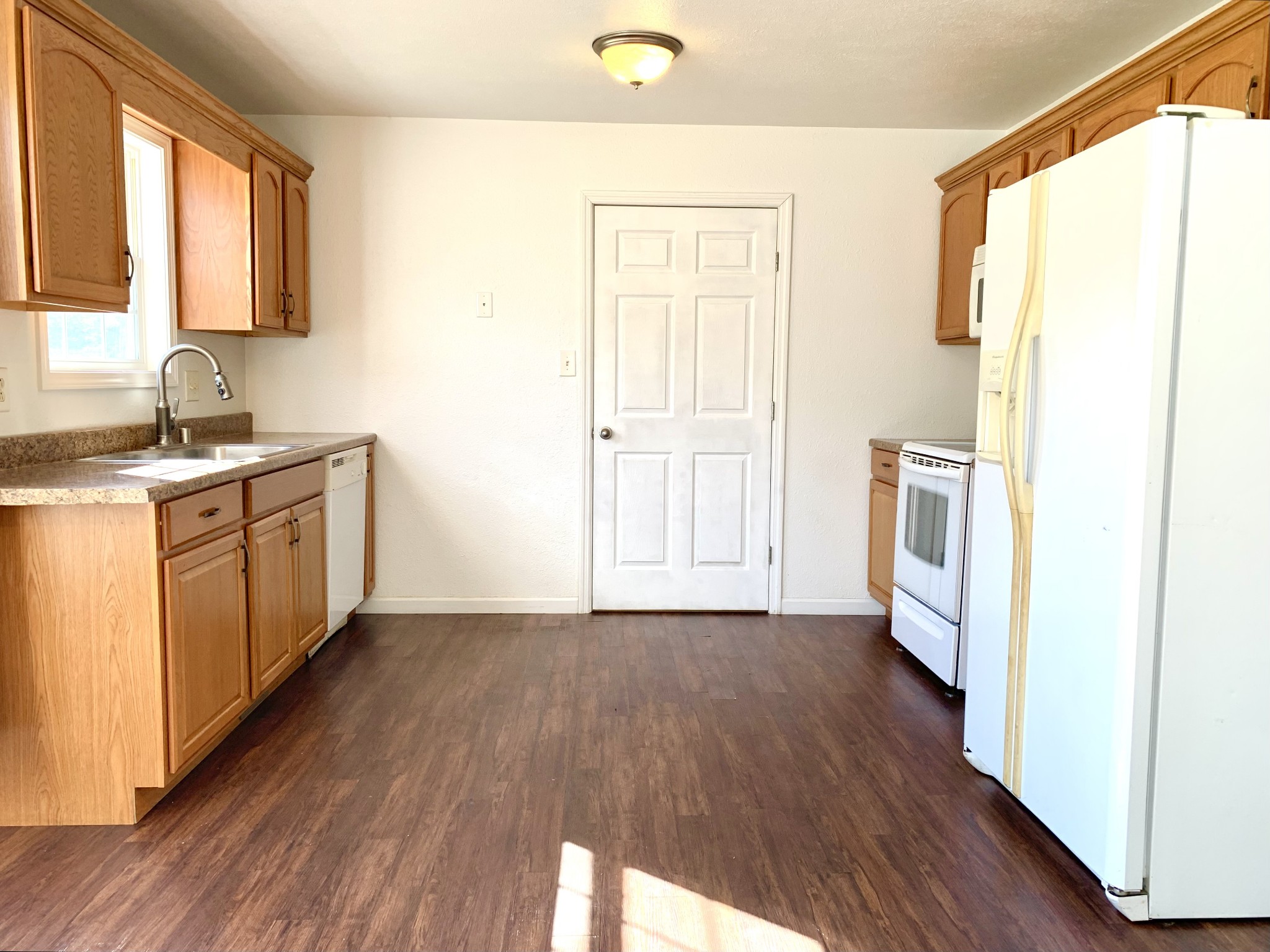 10543 Bell Station Road Oak Grove, KY 42262 - Photo 11 of 41 a kitchen with a sink a refrigerator and wooden floor