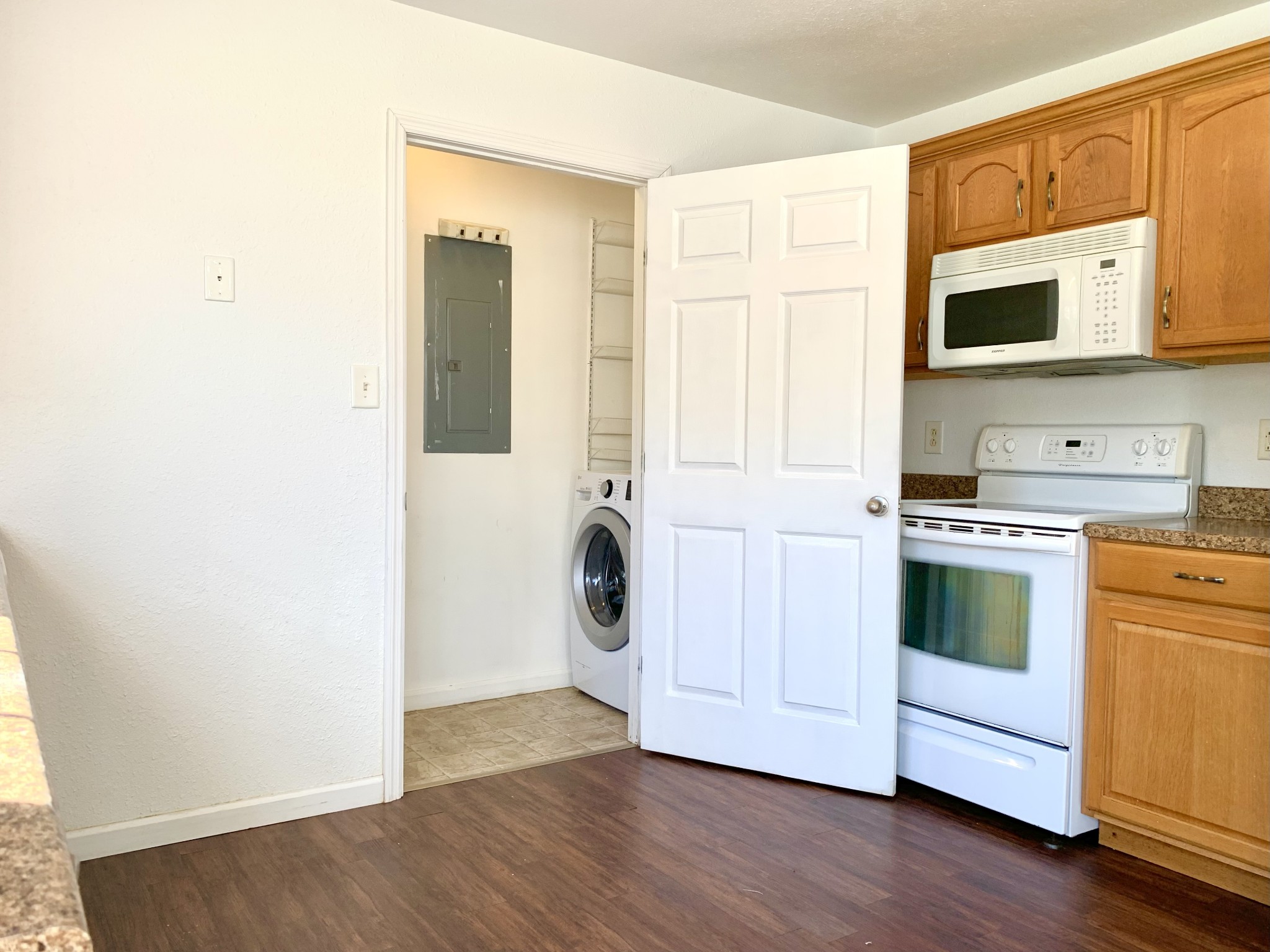 10543 Bell Station Road Oak Grove, KY 42262 - Photo 14 of 41 a kitchen with stainless steel appliances white cabinets and wooden floor