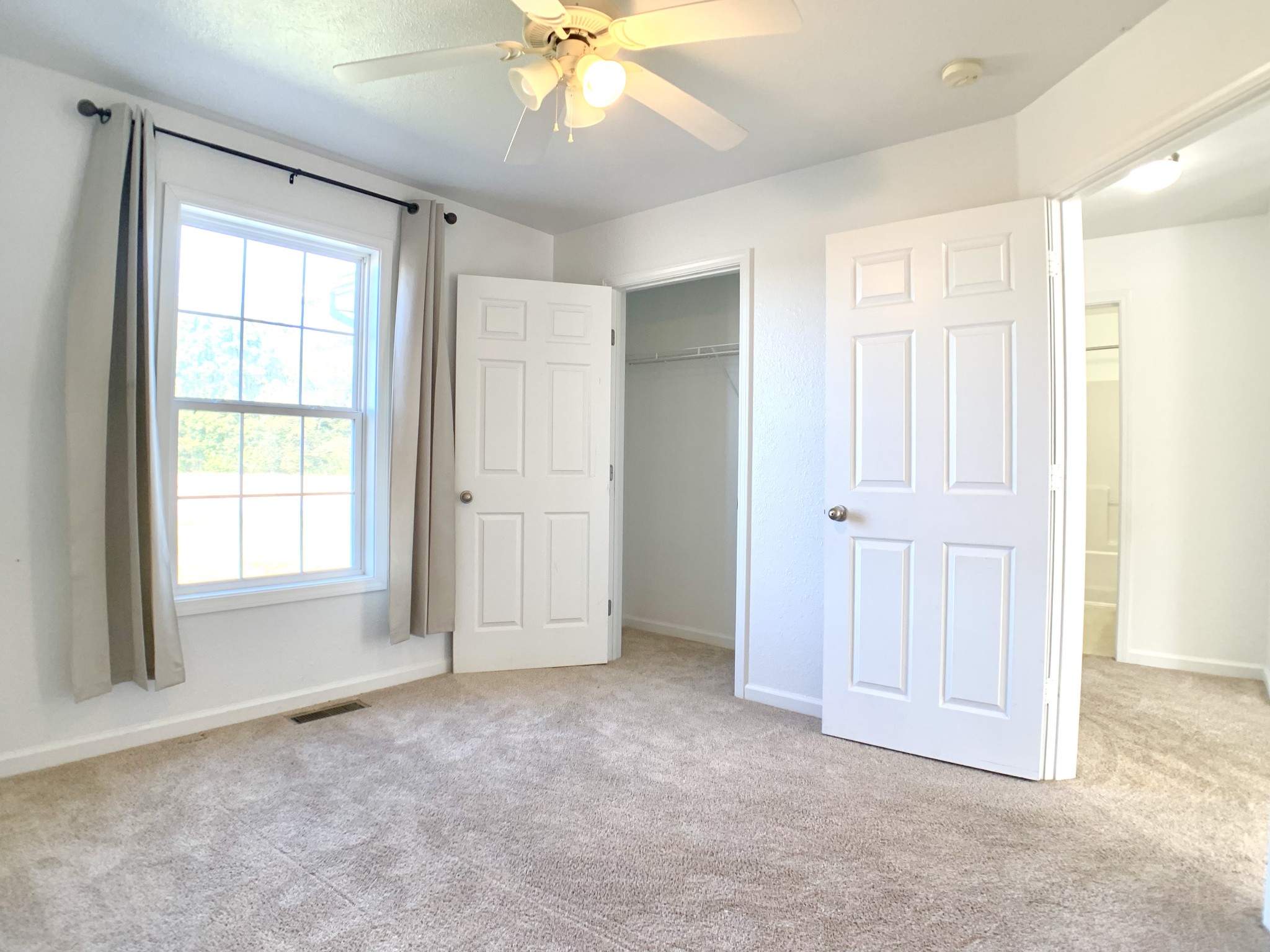 10543 Bell Station Road Oak Grove, KY 42262 - Photo 17 of 41 an empty room with windows and fan