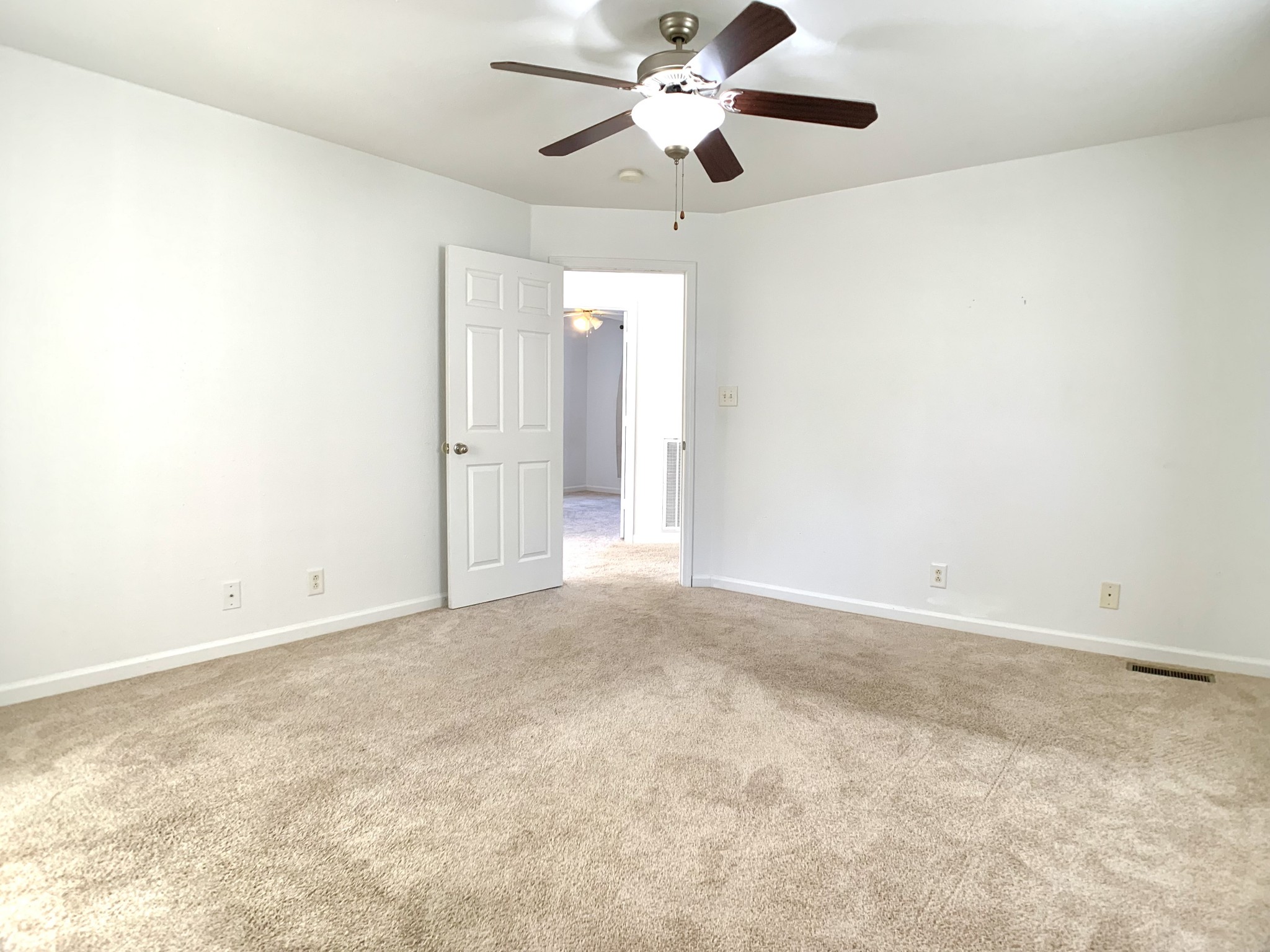 10543 Bell Station Road Oak Grove, KY 42262 - Photo 25 of 41 an empty room with a chandelier fan and windows