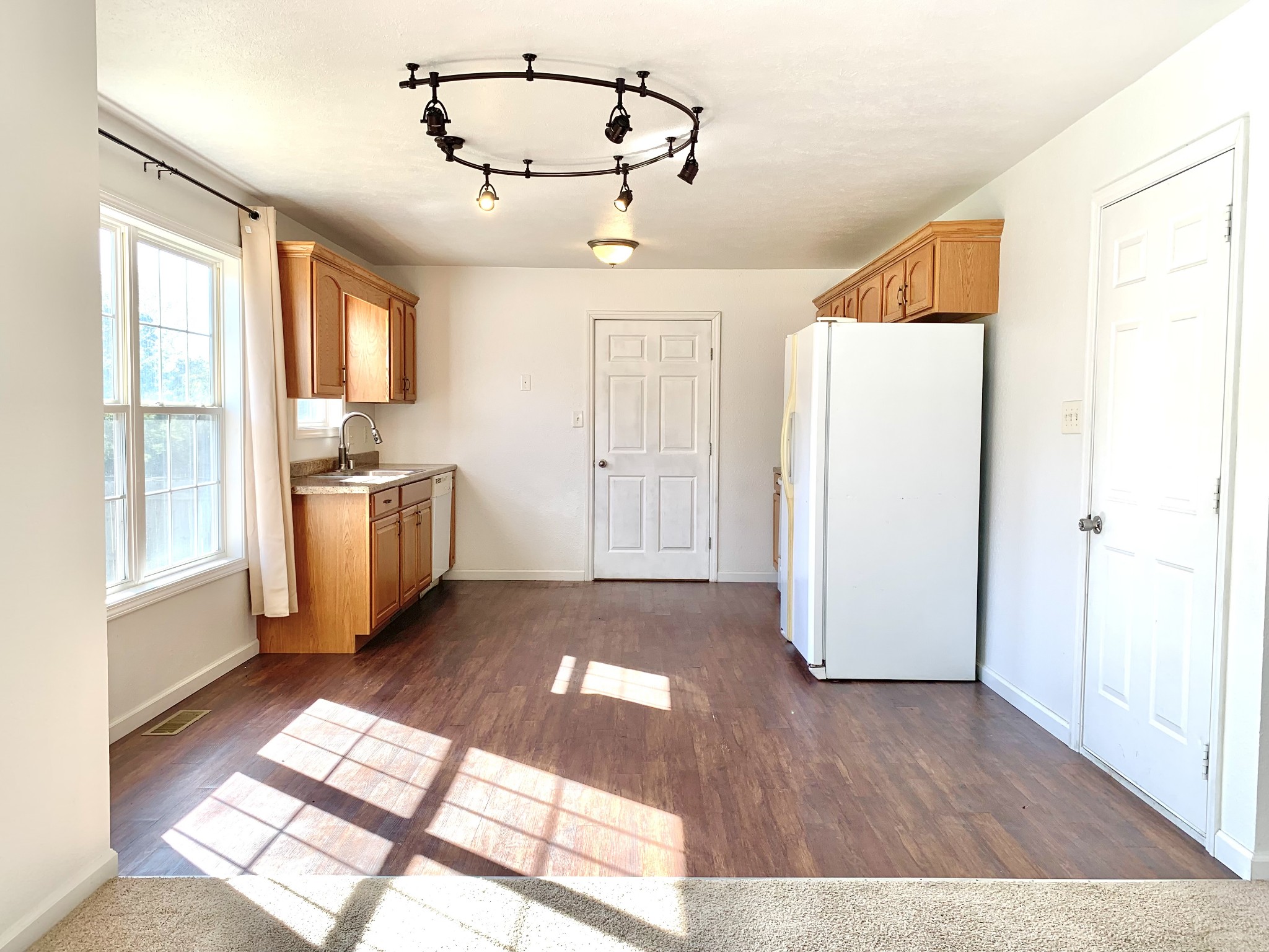 10543 Bell Station Road Oak Grove, KY 42262 - Photo 7 of 41 a view of a kitchen with wooden floor and electronic appliances