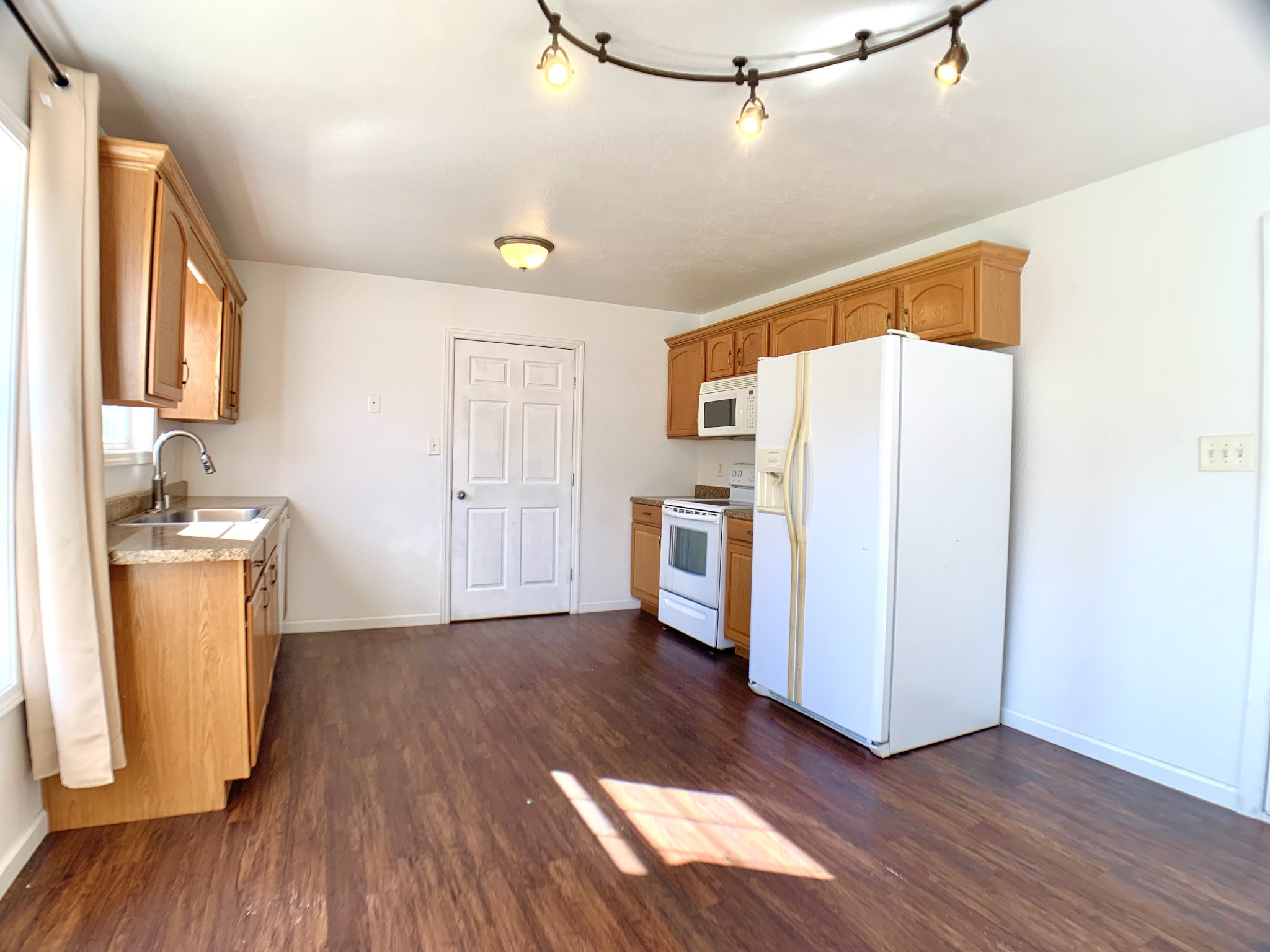 10543 Bell Station Road Oak Grove, KY 42262 - Photo 10 of 41 a kitchen with granite countertop a refrigerator a sink and wooden floor