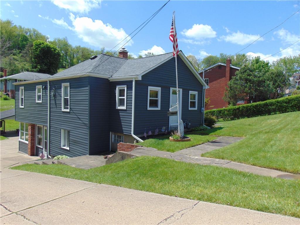 5569 Aiken Road McKees Rocks, PA 15136 - Photo 1 of 24 a view of a yard in front of a house with large windows