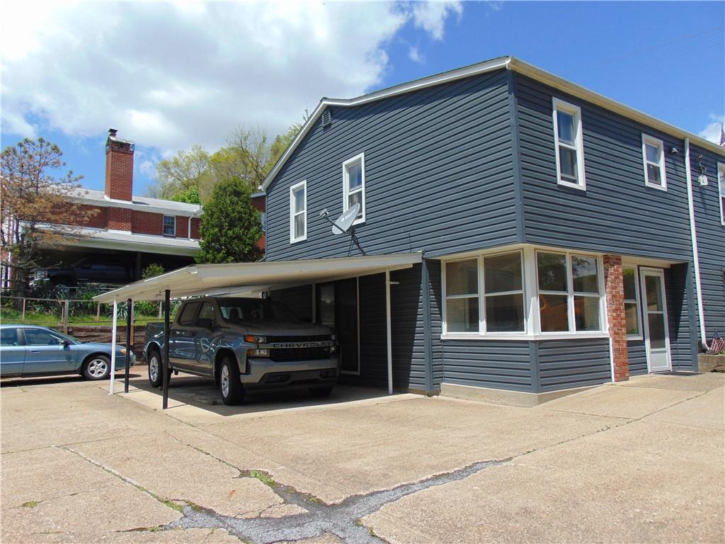 5569 Aiken Road McKees Rocks, PA 15136 - Photo 2 of 24 a front view of a house with a parking space