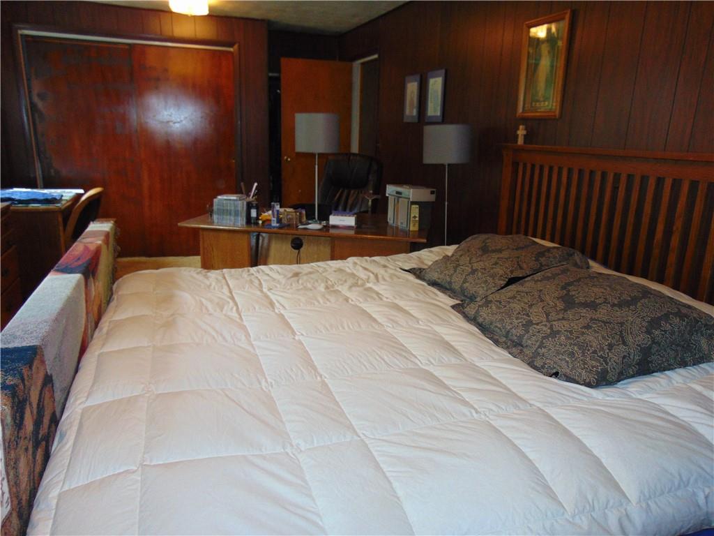 5569 Aiken Road McKees Rocks, PA 15136 - Photo 15 of 24 a bed room with a bed window and a chair
