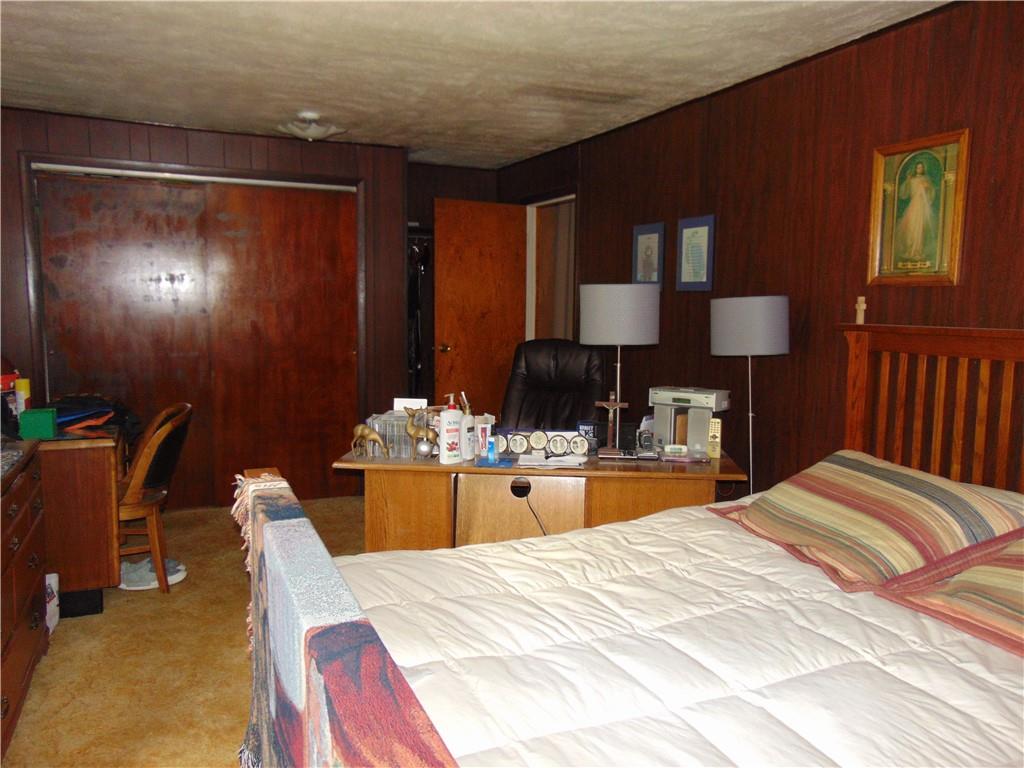 5569 Aiken Road McKees Rocks, PA 15136 - Photo 16 of 24 a bed room with a bed and a table