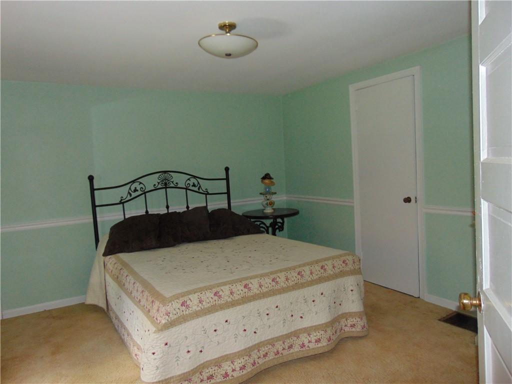 5569 Aiken Road McKees Rocks, PA 15136 - Photo 17 of 24 a bedroom with a bed and chandelier