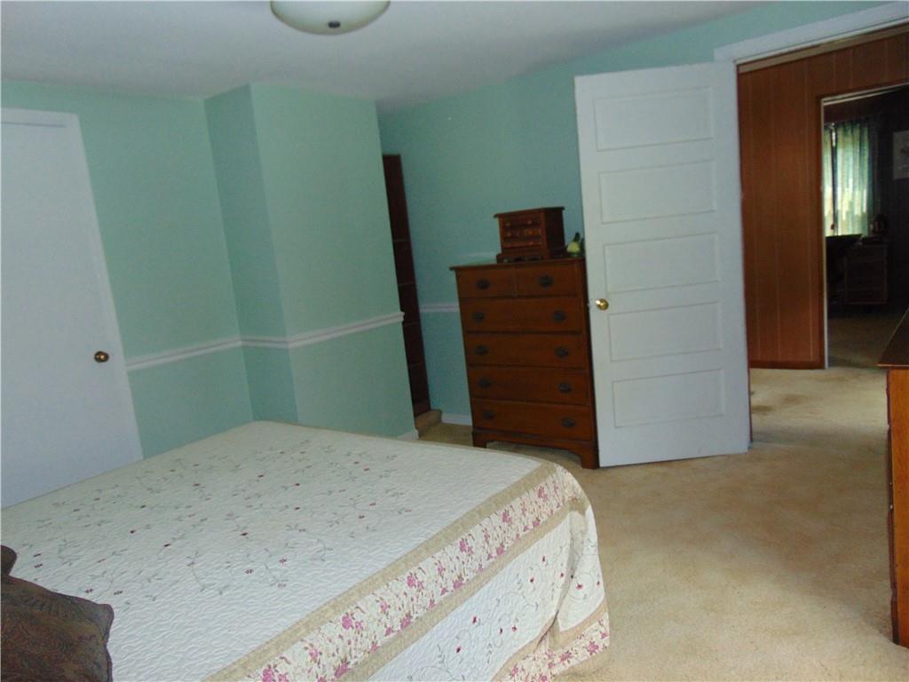 5569 Aiken Road McKees Rocks, PA 15136 - Photo 18 of 24 a bedroom with a bed and a mirror