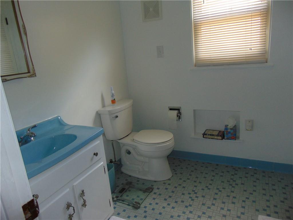 5569 Aiken Road McKees Rocks, PA 15136 - Photo 21 of 24 a bathroom with a granite countertop toilet and a sink
