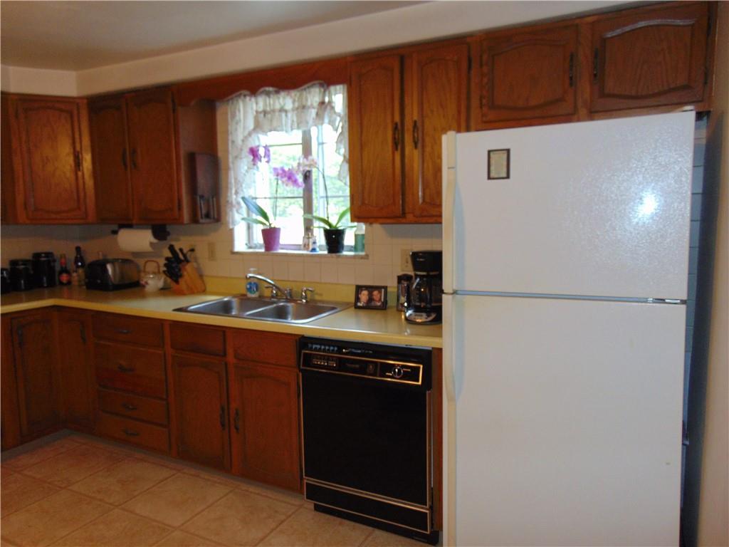 5569 Aiken Road McKees Rocks, PA 15136 - Photo 10 of 24 a kitchen with a refrigerator and a sink