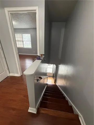 a view of entryway and hall with wooden floor