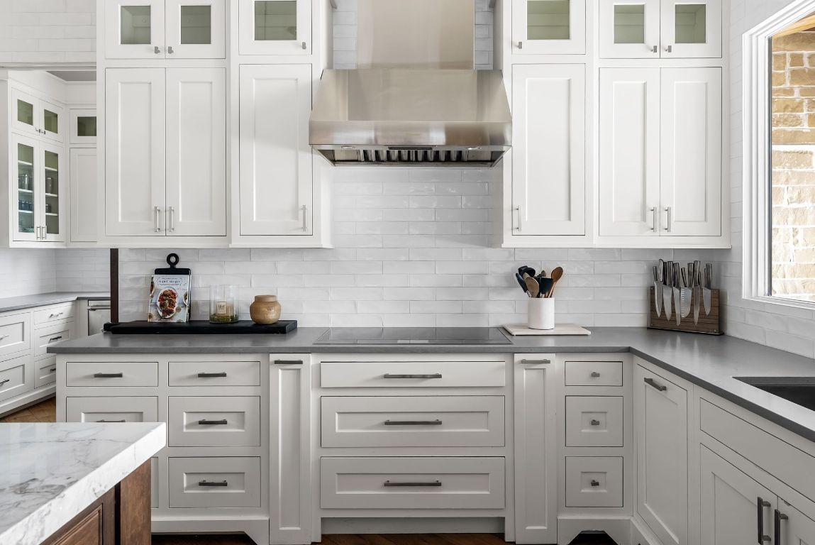 12109 Musket Rim Street Austin, TX 78738 - Photo 13 of 38 a kitchen with granite countertop white cabinets and white appliances