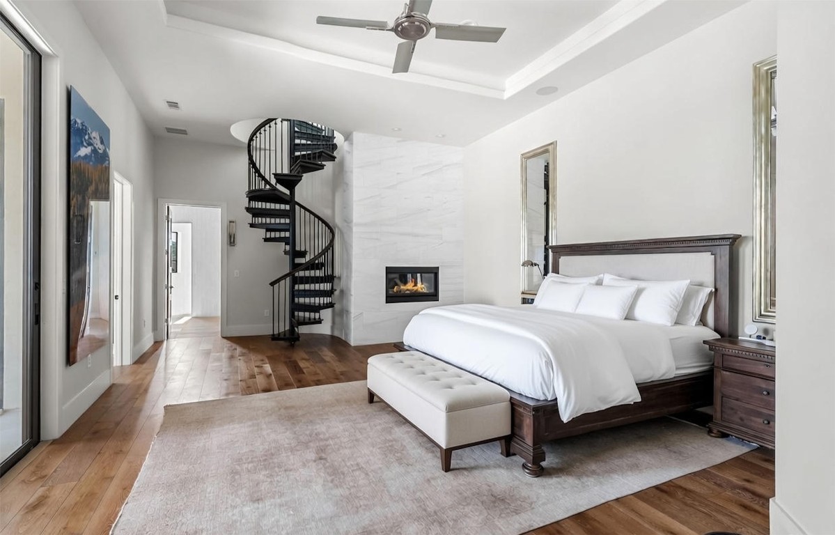 12109 Musket Rim Street Austin, TX 78738 - Photo 16 of 38 a spacious bedroom with a bed and a chandelier