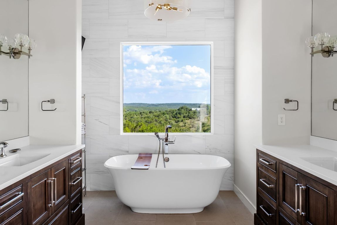 12109 Musket Rim Street Austin, TX 78738 - Photo 18 of 38 a spacious bathroom with a bathtub and sink