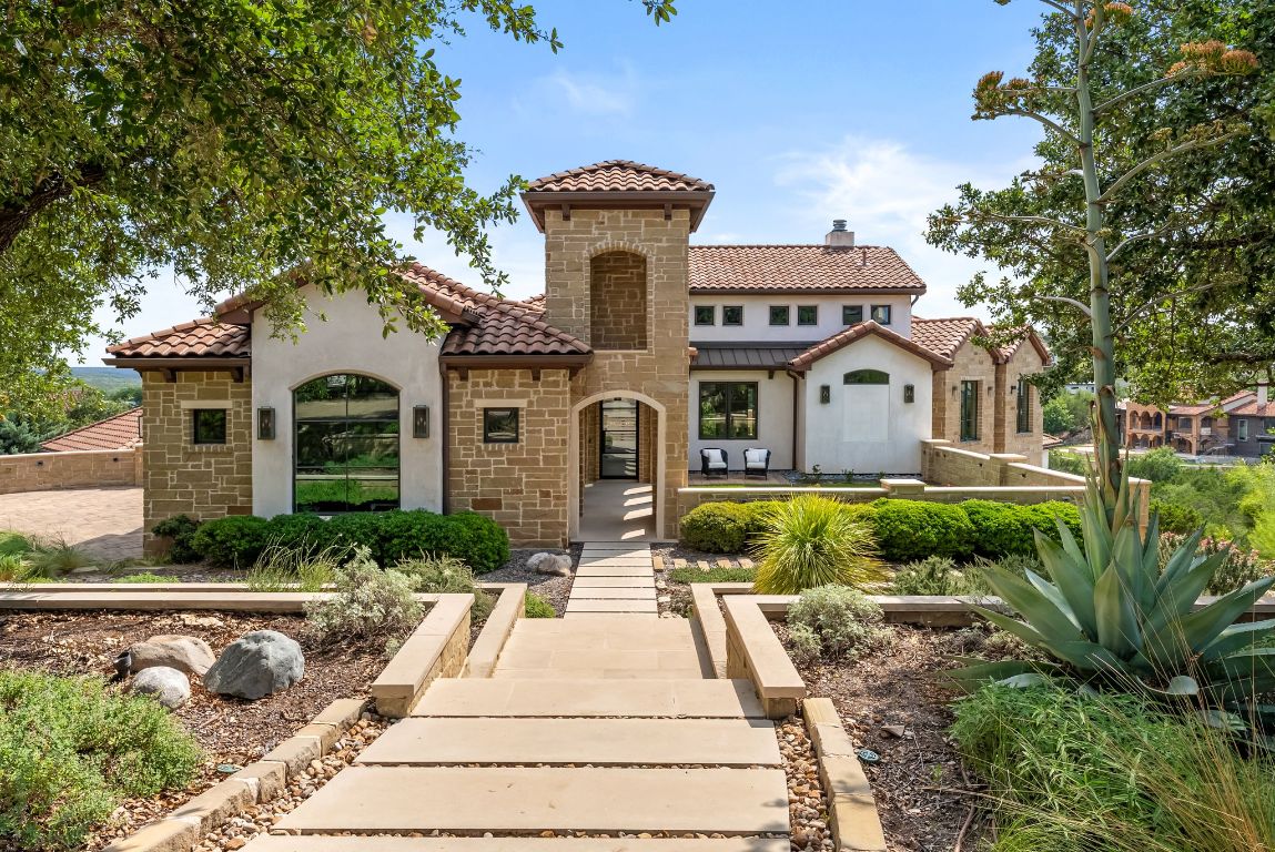 12109 Musket Rim Street Austin, TX 78738 - Photo 2 of 38 a front view of a house with a yard