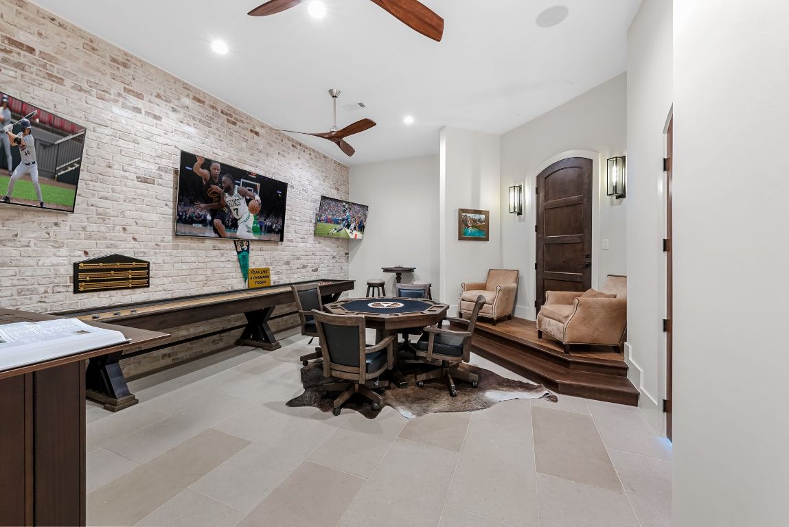 12109 Musket Rim Street Austin, TX 78738 - Photo 22 of 38 a living room with furniture and a flat screen tv