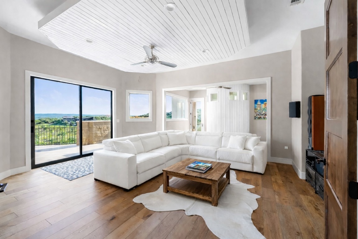 12109 Musket Rim Street Austin, TX 78738 - Photo 24 of 38 a living room with furniture and a large window