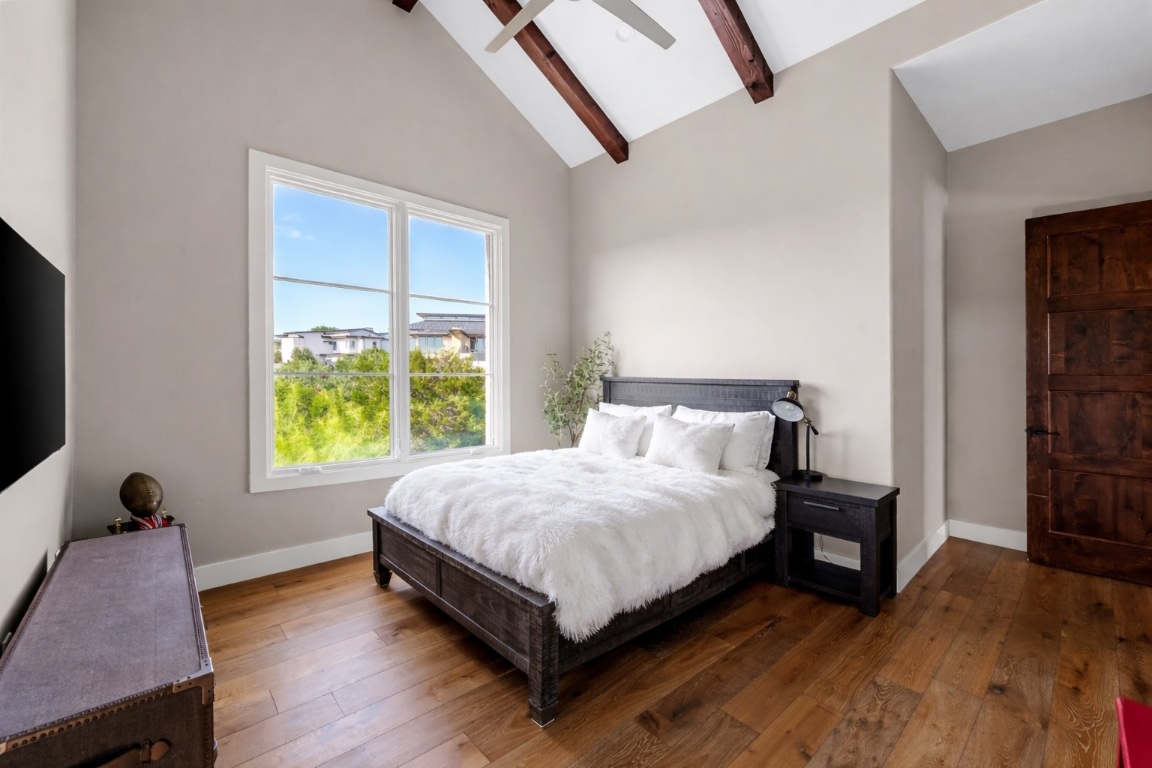 12109 Musket Rim Street Austin, TX 78738 - Photo 27 of 38 a bed sitting in a bedroom next to a window