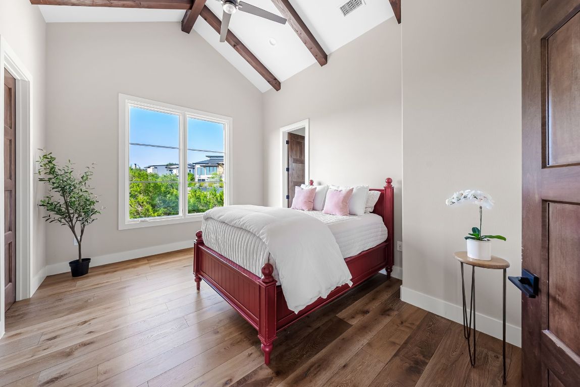 12109 Musket Rim Street Austin, TX 78738 - Photo 29 of 38 a bed sitting in a bedroom next to a window