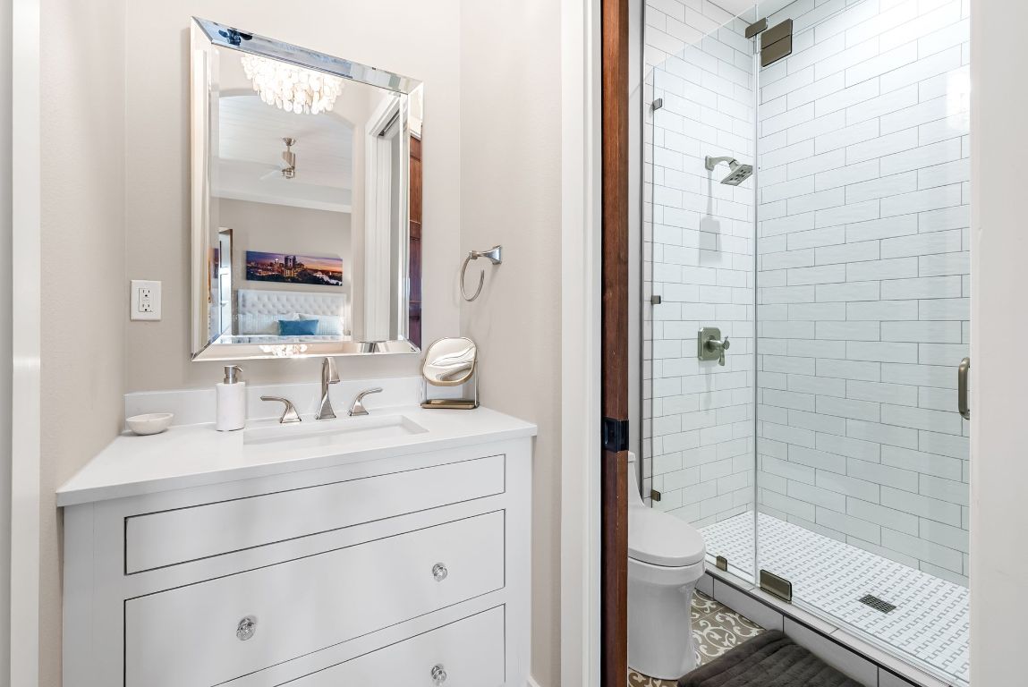 12109 Musket Rim Street Austin, TX 78738 - Photo 30 of 38 a bathroom with a double vanity sink mirror and shower