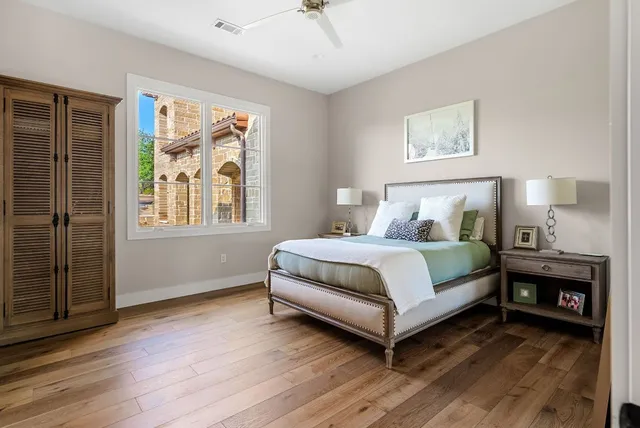 a bedroom with a bed and a night stand