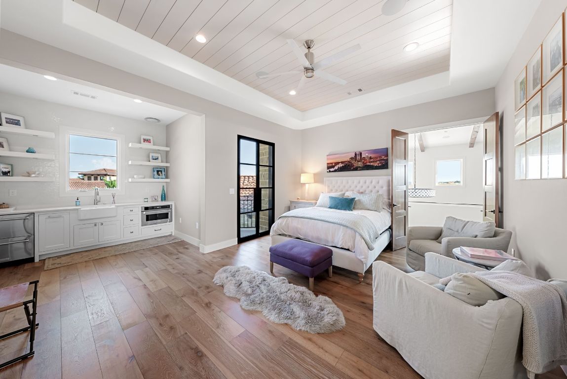 12109 Musket Rim Street Austin, TX 78738 - Photo 32 of 38 a bedroom with furniture and a wooden floor