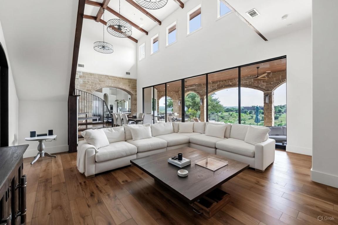 12109 Musket Rim Street Austin, TX 78738 - Photo 10 of 38 a living room with furniture large window and wooden floor