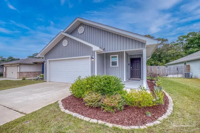 a front view of a house with garden