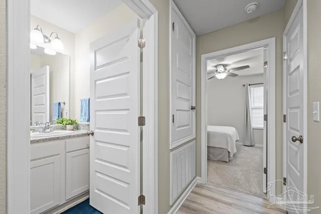 a en suite bathroom with a granite countertop sink mirror and toilet