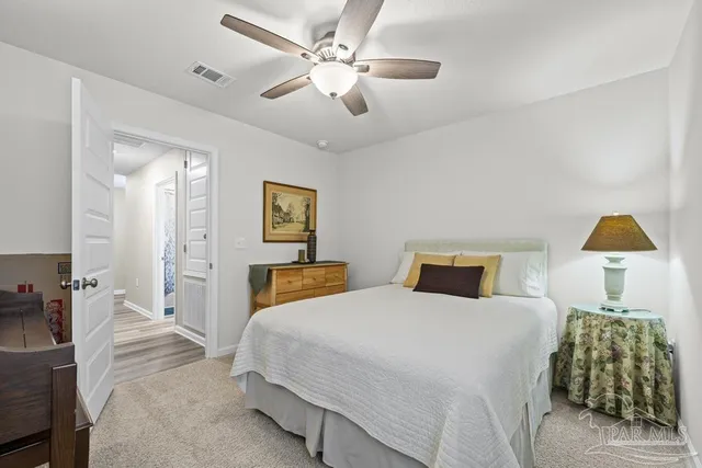 a bedroom with a bed and a lamp