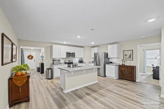 a kitchen with stainless steel appliances stove refrigerator sink and cabinets